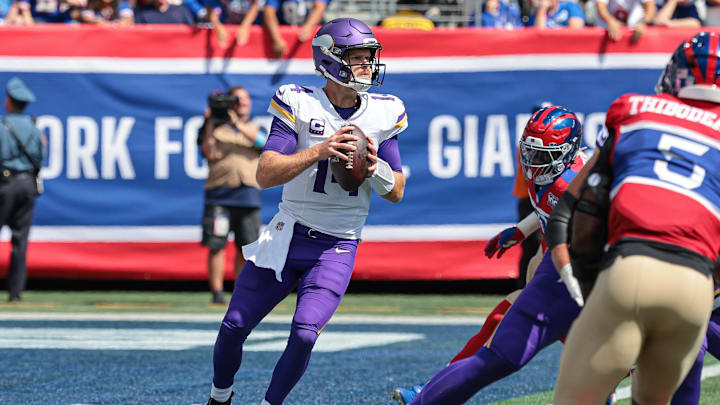 Sep 8, 2024; East Rutherford, New Jersey, USA; Minnesota Vikings quarterback Sam Darnold (14) drops back to pass during the first quarter against the New York Giants at MetLife Stadium. Mandatory Credit: Vincent Carchietta-Imagn Images