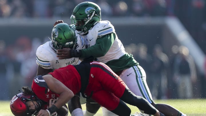 Nov 25, 2022; Cincinnati, Ohio, USA; Tulane Green Wave linebacker Nick Anderson (1) and defensive lineman Patrick Jenkins (0) tackle Cincinnati Bearcats quarterback Evan Prater (3) in the second half at Nippert Stadium. 