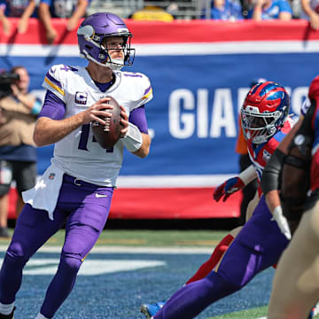 Sep 8, 2024; East Rutherford, New Jersey, USA; Minnesota Vikings quarterback Sam Darnold (14) drops back to pass during the first quarter against the New York Giants at MetLife Stadium.