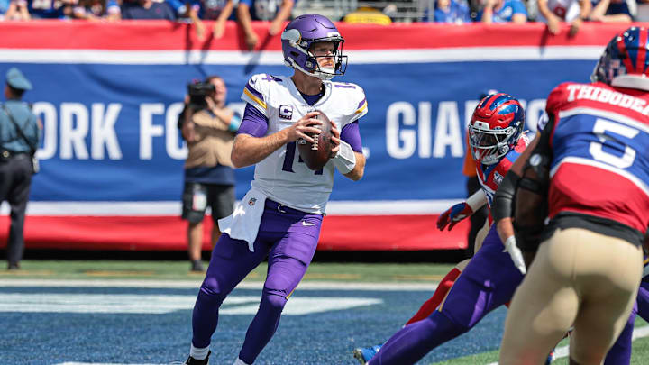 Sep 8, 2024; East Rutherford, New Jersey, USA; Minnesota Vikings quarterback Sam Darnold (14) drops back to pass during the first quarter against the New York Giants at MetLife Stadium.