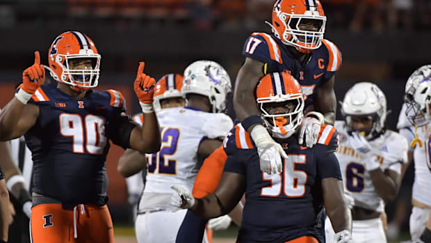 Aug 29, 2025; Champaign, Illinois, USA;  Illinois Fighting Illini linebacker Gabe Jacas (17) jumps on a teammate