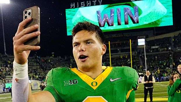 Oregon quarterback Dillon Gabriel posts a video on social media on his way off the field after defeating Maryland at Autzen S