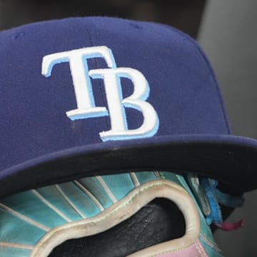 Sep 26, 2025; Toronto, Ontario, CAN; The hat and glove of Tampa Bay Rays third baseman Junior Caminero (13) in the dugout during the game against the Toronto Blue Jays at Rogers Centre. 