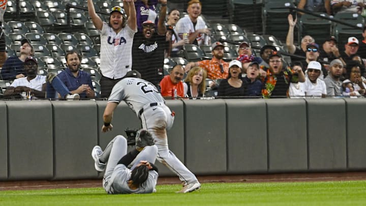 Sep 3, 2024; Baltimore, Maryland, USA;  Chicago White Sox outfielder Miguel Vargas (20) and  outfielder Andrew Benintendi (23) react after colliding on Baltimore Orioles designated hitter Eloy Jiménez (not pictured) second inning fly ball  at Oriole Park at Camden Yards. Mandatory Credit: Tommy Gilligan-Imagn Images