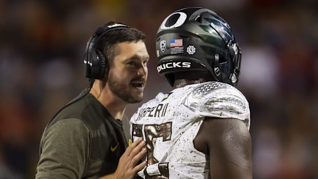 Oregon Ducks head coach Dan Lanning with offensive lineman Marcus Harper II