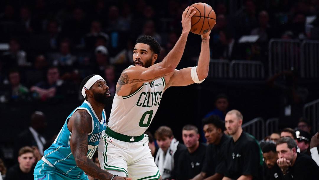 Oct 14, 2026; Boston, Massachusetts, USA;  Charlotte Hornets forward Royce O'Neale (00) guards Boston Celtics forward Jayson Tatum (0) during the second half at TD Garden. Mandatory Credit: Bob DeChiara-Imagn Images
