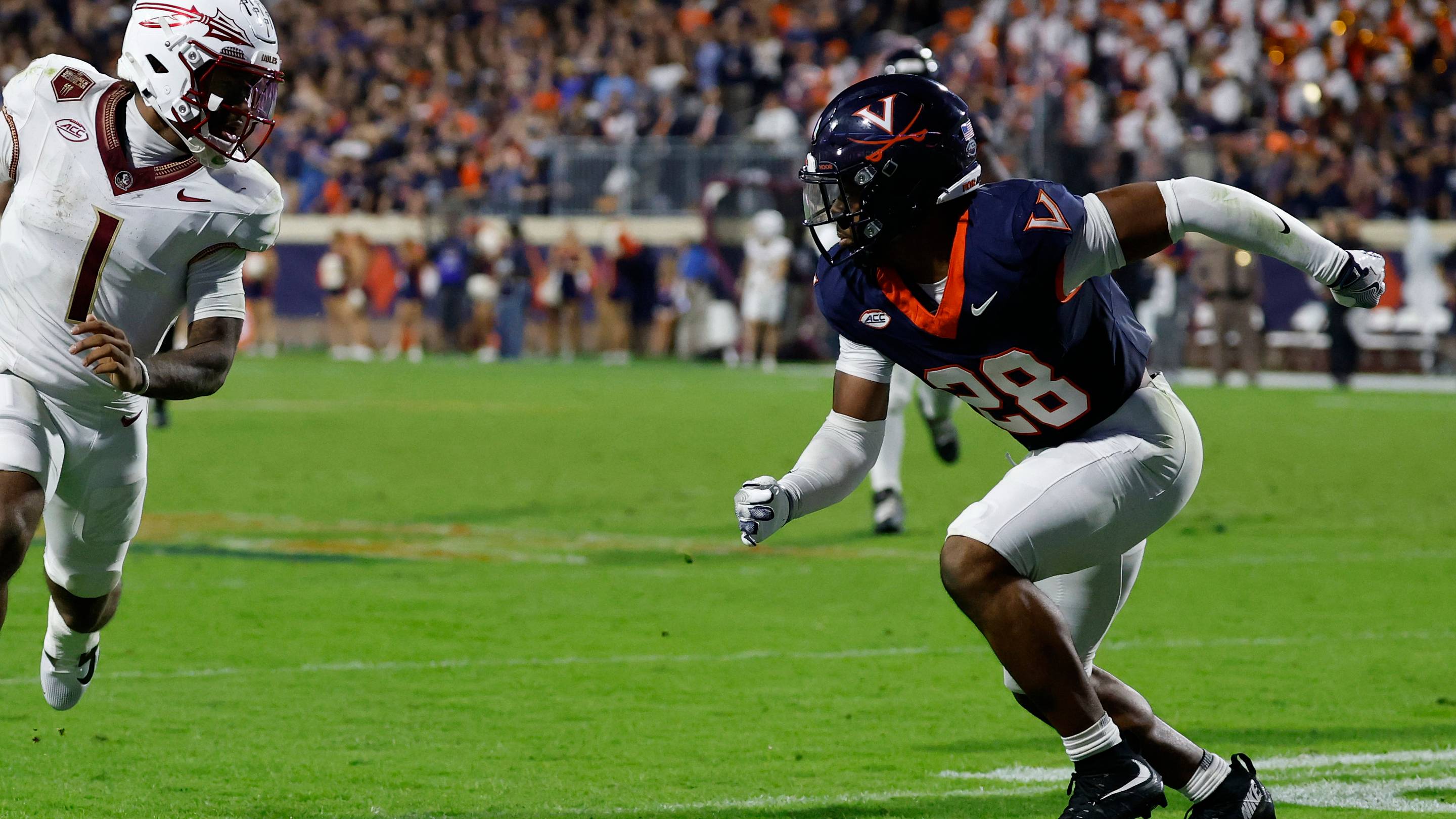 Sep 26, 2025; Charlottesville, Virginia, USA; Florida State Seminoles quarterback Tommy Castellanos (1) runs with the ball as Virginia Cavaliers defensive back Donavon Platt (28) chases at Scott Stadium. Mandatory Credit: Geoff Burke-Imagn Images