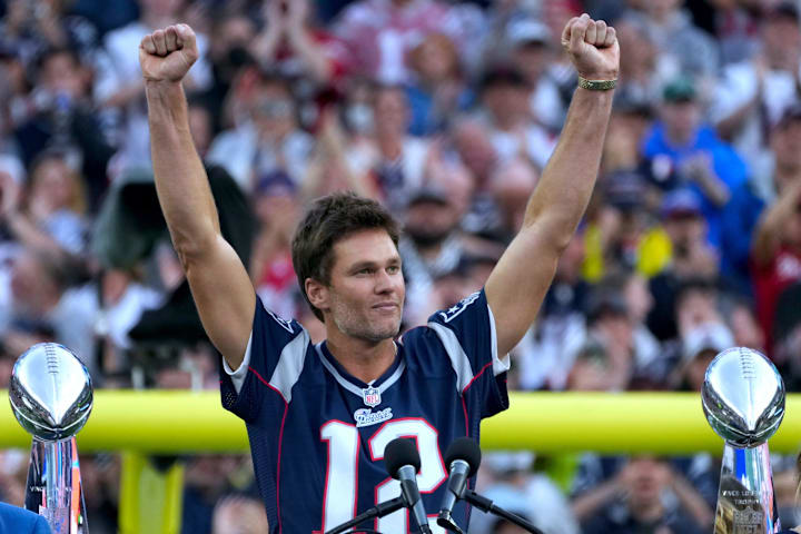 Tom Brady acknowledges fans during a halftime celebration and the announcement of his induction in Patriots Hall of Fame.  