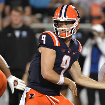 Aug 29, 2024; Champaign, Illinois, USA;  Illinois Fighting Illini quarterback Luke Altmyer (9) hands the ball to teammate Illinois Fighting Illini running back Aidan Laughery (21) during the second half at Memorial Stadium. Mandatory Credit: Ron Johnson-USA TODAY Sports