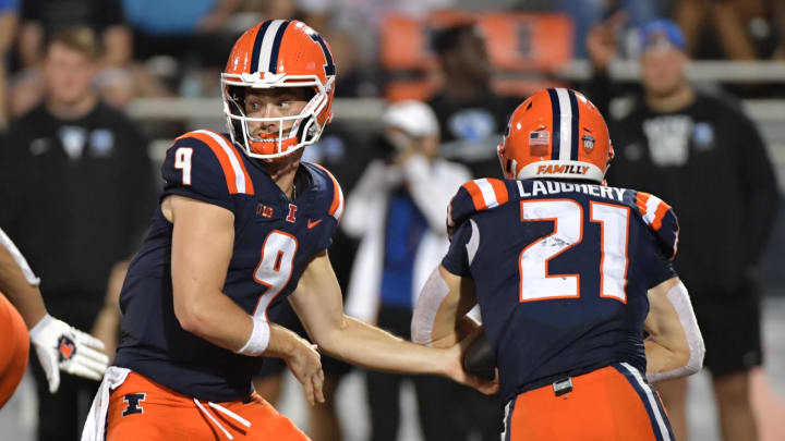 Aug 29, 2024; Champaign, Illinois, USA;  Illinois Fighting Illini quarterback Luke Altmyer (9) hands the ball to teammate Illinois Fighting Illini running back Aidan Laughery (21) during the second half at Memorial Stadium. Mandatory Credit: Ron Johnson-USA TODAY Sports