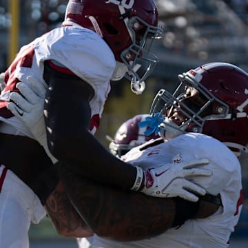Alabama Crimson Tide running back Jam Miller (26) and Alabama Crimson Tide offensive lineman Kadyn Proctor (74) celebrate Miller's touchdown against the Vanderbilt Commodores during their game at Vanderbilt Stadium in Nashville, Tenn., Saturday, Oct. 5, 2024.