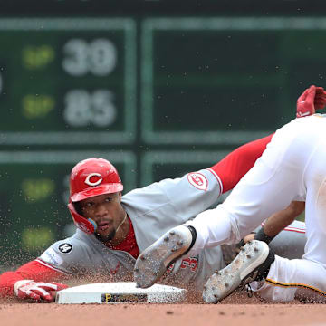 May 21, 2025; Pittsburgh, Pennsylvania, USA;  Pittsburgh Pirates shortstop Isiah Kiner-Falefa (7) tags Cincinnati Reds outfielder Will Benson (30) out at second base on a steal attempt during the eighth inning at PNC Park. Mandatory Credit: Charles LeClaire-Imagn Images