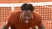 Gael Monfils reacts to winning a five-set match at the French Open.