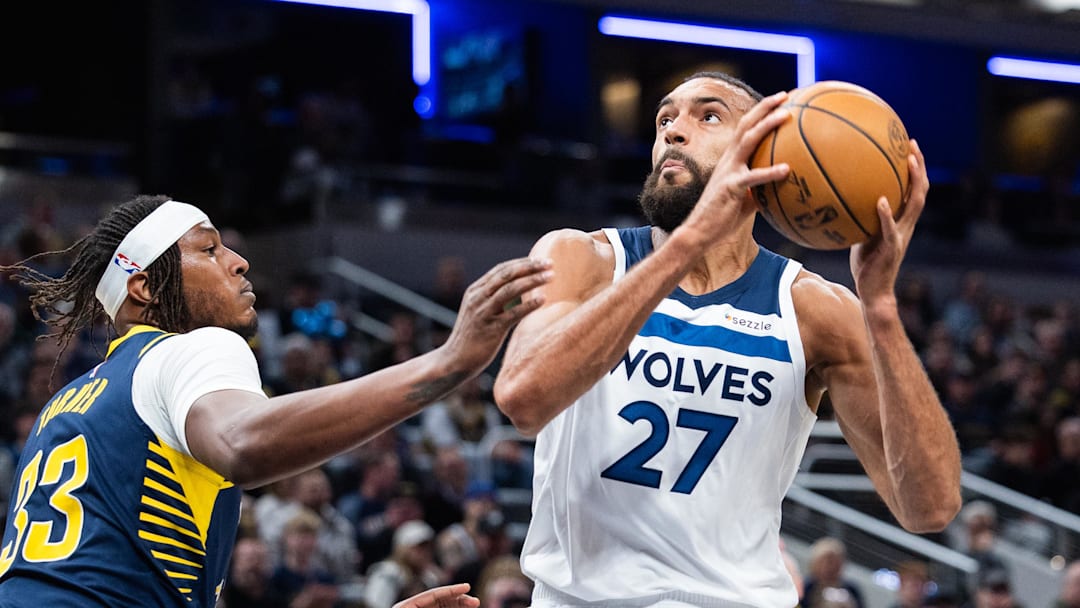Mar 24, 2025; Indianapolis, Indiana, USA; Minnesota Timberwolves center Rudy Gobert (27) shoots the ball while   Indiana Pacers center Myles Turner (33) defends in the first half at Gainbridge Fieldhouse. Mandatory Credit: Trevor Ruszkowski-Imagn Images