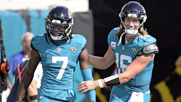Oct 27, 2024; Jacksonville, Florida, USA; Jacksonville Jaguars quarterback Trevor Lawrence (16) celebrates a touchdown with wide receiver Brian Thomas Jr. (7) during the second half against the Green Bay Packers at EverBank Stadium. Mandatory Credit: Melina Myers-Imagn Images