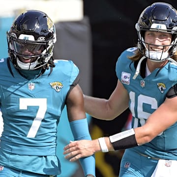 Oct 27, 2024; Jacksonville, Florida, USA; Jacksonville Jaguars quarterback Trevor Lawrence (16) celebrates a touchdown with wide receiver Brian Thomas Jr. (7) during the second half against the Green Bay Packers at EverBank Stadium. Mandatory Credit: Melina Myers-Imagn Images