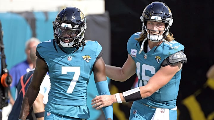 Oct 27, 2024; Jacksonville, Florida, USA; Jacksonville Jaguars quarterback Trevor Lawrence (16) celebrates a touchdown with wide receiver Brian Thomas Jr. (7) during the second half against the Green Bay Packers at EverBank Stadium. 