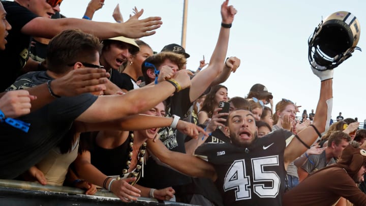 Purdue Boilermakers running back Devin Mockobee (45) jumps into the student section after a game