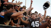 Purdue Boilermakers running back Devin Mockobee (45) jumps into the student section 
