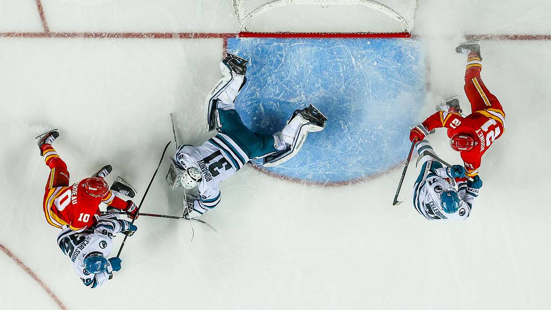 Apr 13, 2025; Calgary, Alberta, CAN; San Jose Sharks goaltender Georgi Romanov (31) makes a save against Calgary Flames left wing Jonathan Huberdeau (10) during the third period at Scotiabank Saddledome. Mandatory Credit: Sergei Belski-Imagn Images