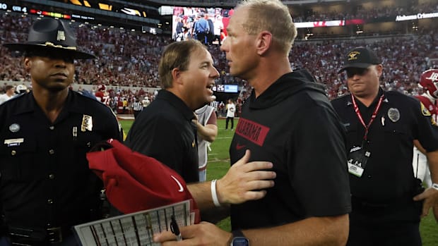 Missouri Tigers head coach Eliah Drinkwitz (left) talks with Alabama Crimson Tide head coach Kalen DeBoer (right) 