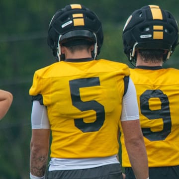 Aug 6, 2025; Columbia, MO, USA; Missouri Tigers quarterbacks Matt Zollers (5), Beau Pribula (9) and Sam Horn (21) walk back during a drill during fall camp at Mizzou Athletic Training Complex.