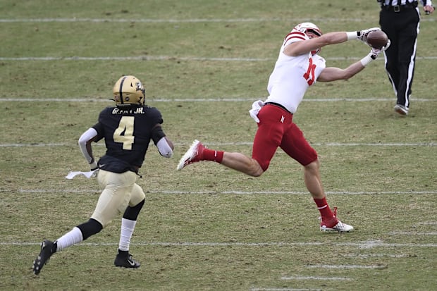 Nebraska Cornhuskers tight end Austin Allen catches a long pass in front of Purdue Boilermakers safety Marvin Grant.