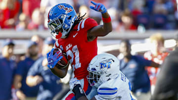 Sep 7, 2024; Oxford, Mississippi, USA; Mississippi Rebels running back Henry Parrish Jr. (21) runs the ball as Middle Tennessee Blue Raiders defensive back Marvae Myers (6) attempts to make the tackle during the second half at Vaught-Hemingway Stadium. Mandatory Credit: Petre Thomas-Imagn Images