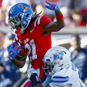 Sep 7, 2024; Oxford, Mississippi, USA; Mississippi Rebels running back Henry Parrish Jr. (21) runs the ball as Middle Tennessee Blue Raiders defensive back Marvae Myers (6) attempts to make the tackle during the second half at Vaught-Hemingway Stadium. Mandatory Credit: Petre Thomas-Imagn Images