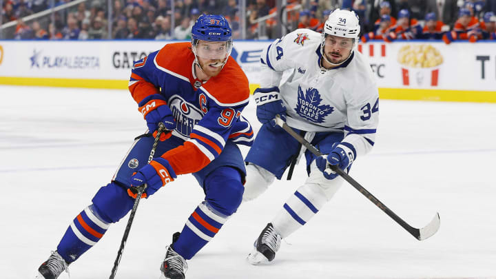 Jan 16, 2024; Edmonton, Alberta, CAN; Edmonton Oilers forward Connor McDavid (97) carries the puck around Toronto Maple Leafs forward Auston Matthews (34) during the first period at Rogers Place. Mandatory Credit: Perry Nelson-USA TODAY Sports
