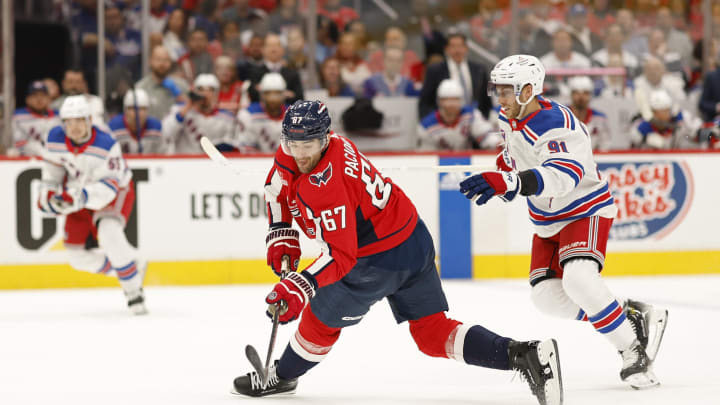 Apr 26, 2024; Washington, District of Columbia, USA; Washington Capitals left wing Max Pacioretty (67) shoots the puck as New York Rangers center Alex Wennberg (91) defends in the first period.in game three of the first round of the 2024 Stanley Cup Playoffs at Capital One Arena. Mandatory Credit: Geoff Burke-USA TODAY Sports