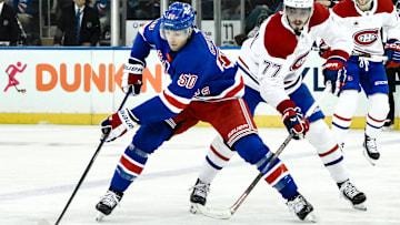 Nov 30, 2024; New York, New York, USA; New York Rangers left wing Will Cuylle (50) skates with the puck against Montreal Canadiens center Kirby Dach (77) during the third period at Madison Square Garden. Mandatory Credit: John Jones-Imagn Images