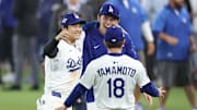 Oct 27, 2025; Los Angeles, California, USA; Los Angeles Dodgers designated hitter Shohei Ohtani (17) celebrates with pitcher Roki Sasaki (11) and pitcher Yoshinobu Yamamoto (18) after winning in the eighteenth inning against the Toronto Blue Jays in game three of the 2025 MLB World Series at Dodger Stadium. Mandatory Credit: Kiyoshi Mio-Imagn Images