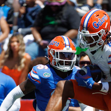 Apr 12, 2025; Gainesville, FL, USA; Florida Gators wide receiver Dallas Wilson (6) makes a catch over Florida Gators defensive back Micheal Caraway Jr. (16) and Florida Gators defensive back Brayden Slade (39) during the first half at Ben Hill Griffin Stadium. Mandatory Credit: Matt Pendleton-Imagn Images