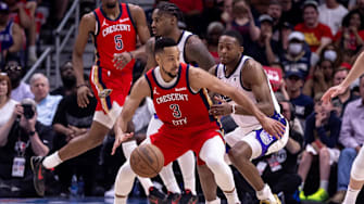 Apr 19, 2024; New Orleans, Louisiana, USA;  New Orleans Pelicans guard CJ McCollum (3) dribbles against Sacramento Kings guard De'Aaron Fox (5) in the second half during a play-in game of the 2024 NBA playoffs at Smoothie King Center.