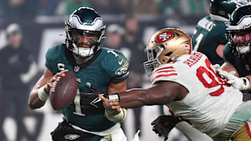 Dec 3, 2023; Philadelphia, Pennsylvania, USA; Philadelphia Eagles quarterback Jalen Hurts (1) is tackled by San Francisco 49ers defensive tackle Javon Hargrave (98) during the fourth quarter at Lincoln Financial Field. Mandatory Credit: Eric Hartline-Imagn Images