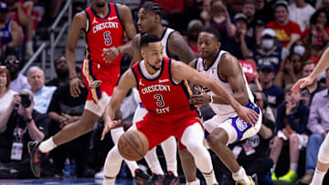 Apr 19, 2024; New Orleans, Louisiana, USA;  New Orleans Pelicans guard CJ McCollum (3) dribbles against Sacramento Kings guard De'Aaron Fox (5) in the second half during a play-in game of the 2024 NBA playoffs at Smoothie King Center.