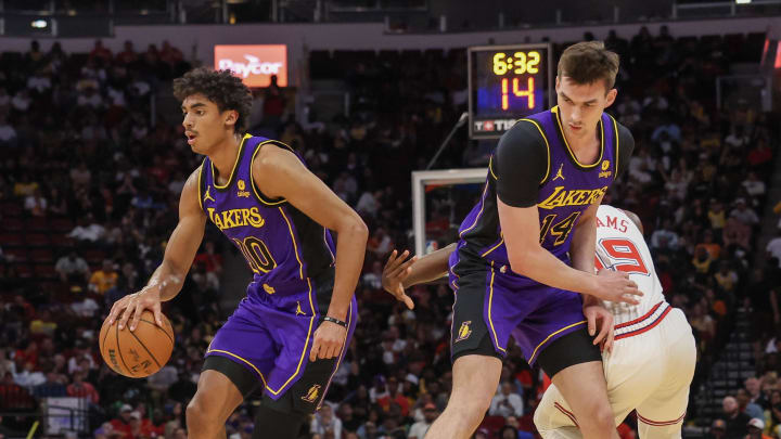 Nov 8, 2023; Houston, Texas, USA; Los Angeles Lakers guard Max Christie (10) dribbles as center Colin Castleton (14) sets up a pick against Houston Rockets guard Nate Williams (19) in the second half at Toyota Center. Mandatory Credit: Thomas Shea-USA TODAY Sports