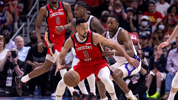 Apr 19, 2024; New Orleans, Louisiana, USA;  New Orleans Pelicans guard CJ McCollum (3) dribbles against Sacramento Kings guard De'Aaron Fox (5) in the second half during a play-in game of the 2024 NBA playoffs at Smoothie King Center.