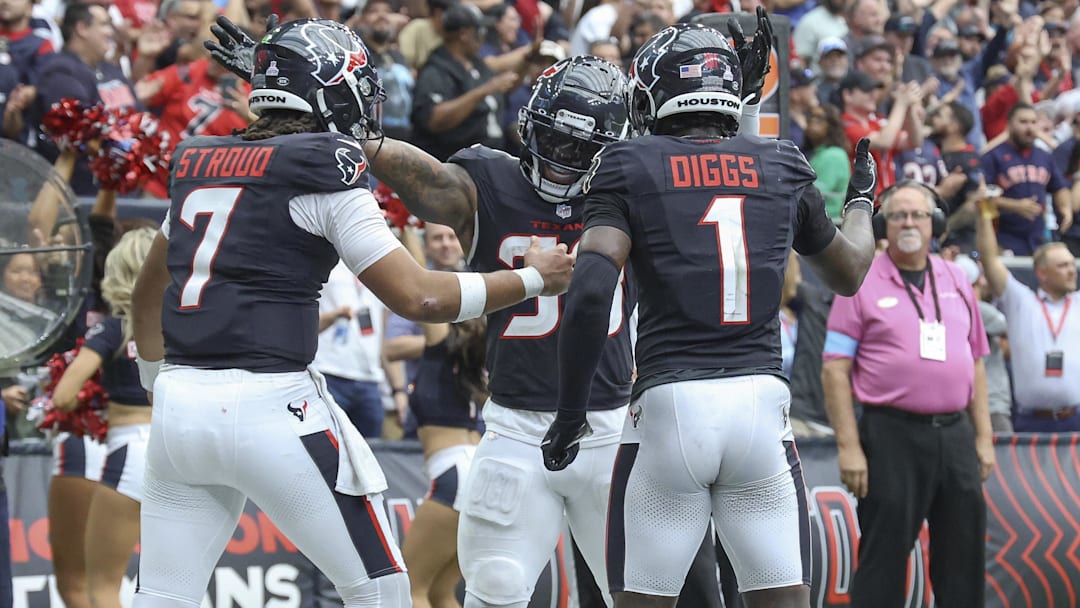 Sep 29, 2024; Houston, Texas, USA; Houston Texans running back Dare Ogunbowale (33) celebrates with quarterback C.J. Stroud (7) and wide receiver Stefon Diggs (1) after scoring a touchdown during the fourth quarter against the Jacksonville Jaguars at NRG Stadium. Mandatory Credit: Troy Taormina-Imagn Images