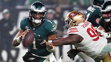 Dec 3, 2023; Philadelphia, Pennsylvania, USA; Philadelphia Eagles quarterback Jalen Hurts (1) is tackled by San Francisco 49ers defensive tackle Javon Hargrave (98) during the fourth quarter at Lincoln Financial Field. Mandatory Credit: Eric Hartline-Imagn Images