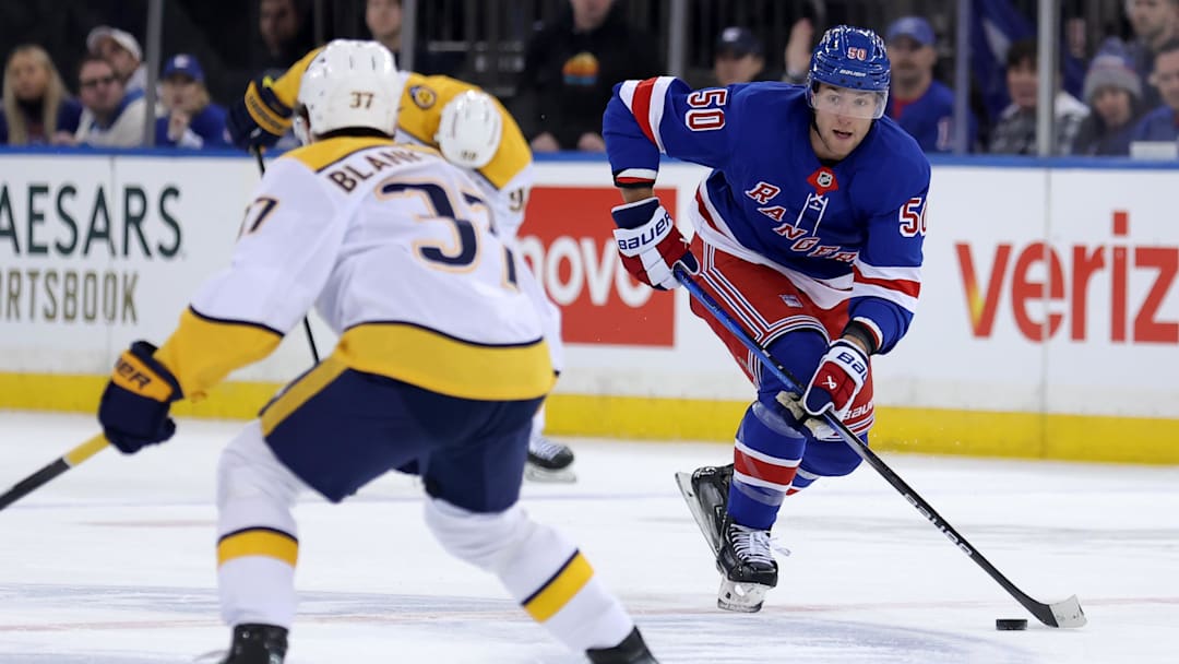 Mar 2, 2025; New York, New York, USA; New York Rangers left wing Will Cuylle (50) brings the puck up ice against Nashville Predators defenseman Nick Blankenburg (37) during the second period at Madison Square Garden. Mandatory Credit: Brad Penner-Imagn Images