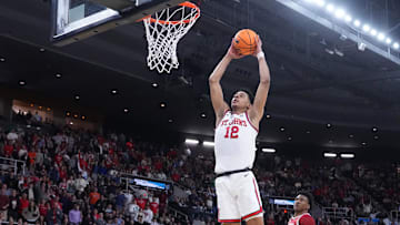 Mar 22, 2025; Providence, RI, USA; St. John's Red Storm guard RJ Luis Jr. (12) dunks against Arkansas Razorbacks forward Karter Knox (11) during the first half of a second round men’s NCAA Tournament game at Amica Mutual Pavilion. Mandatory Credit: Gregory Fisher-Imagn Images