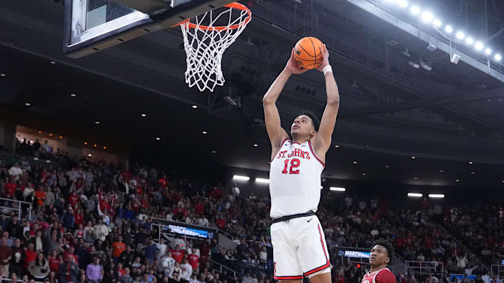 Mar 22, 2025; Providence, RI, USA; St. John's Red Storm guard RJ Luis Jr. (12) dunks against Arkansas Razorbacks forward Karter Knox (11) during the first half of a second round men’s NCAA Tournament game at Amica Mutual Pavilion. Mandatory Credit: Gregory Fisher-Imagn Images