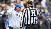 Nov 29, 2025; Pittsburgh, Pennsylvania, USA;  Pittsburgh Panthers head coach Pat Narduzzi reacts to head linesman Kirk Lewis (right) during the first quarter against the Miami Hurricanes at Acrisure Stadium. Mandatory Credit: Charles LeClaire-Imagn Images