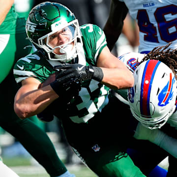 New York Jets running back Isaiah Davis (32) is tackled by Buffalo Bills defensive tackle T.J. Sanders (98), Sunday, September 14, 2025, in East Rutherford.