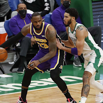 Jan 30, 2021; Boston, Massachusetts, USA; Los Angeles Lakers forward LeBron James (23) works on Boston Celtics forward Jayson Tatum (0) during the second quarter at TD Garden. Mandatory Credit: Winslow Townson-Imagn Images