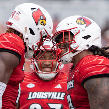 Louisville Cardinals defensive lineman Tramel Logan (19) celebrates with Corey Thornton (14) after sacking Austin Peay Governors running back O'Shaan Allison (0) during their game on Saturday, Aug. 31, 2024 at L&N Federal Credit Union Stadium in Louisville, Ky.