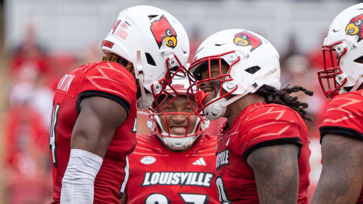 Louisville Cardinals defensive lineman Tramel Logan (19) celebrates with Corey Thornton (14) after sacking Austin Peay Governors running back O'Shaan Allison (0) during their game on Saturday, Aug. 31, 2024 at L&N Federal Credit Union Stadium in Louisville, Ky.