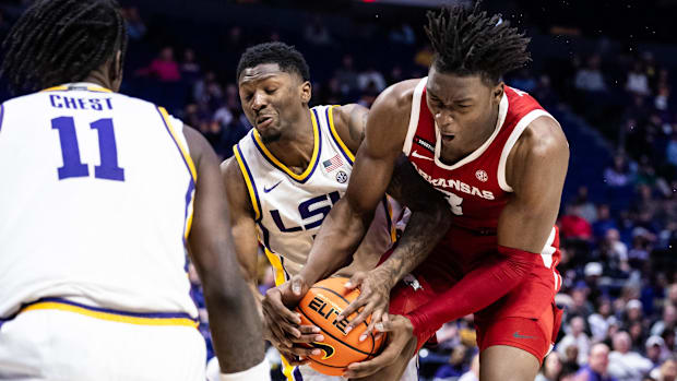 Razorbacks forward Adou Thiero (3) and LSU guard Cam Carter (5) fight for possession of the ball